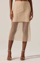 Load image into Gallery viewer, Model wearing the Messina Skirt, a shimmering beaded mesh midi skirt with sheer hem and side slit.