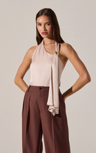 Load image into Gallery viewer, Woman wearing a beige halter top and brown pants against a plain background