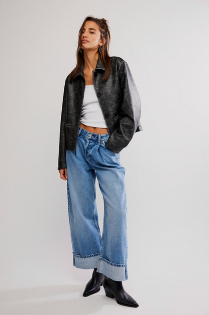 Woman wearing the Alia Wide Leg Jeans Beacon, vintage-inspired wide-leg denim with tacked cuffs.