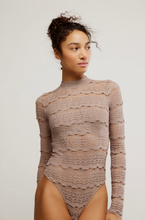 Load image into Gallery viewer, Woman wearing the Angelina Bodysuit, a sheer lace mock neck bodysuit with cutout back detail.