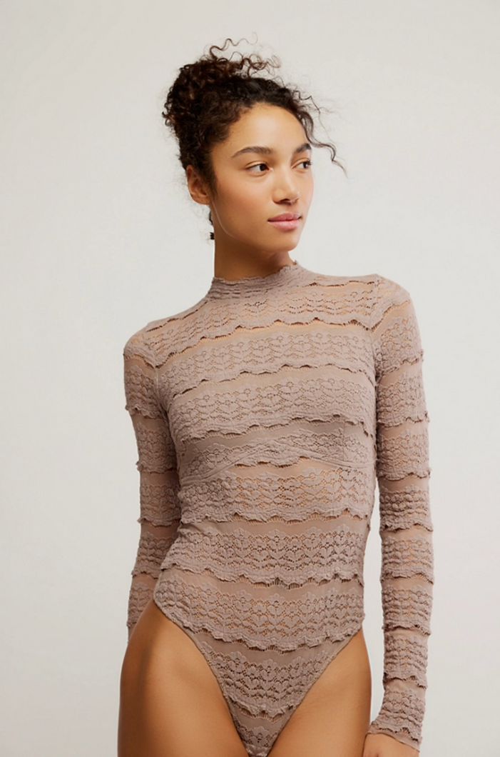 Woman wearing the Angelina Bodysuit, a sheer lace mock neck bodysuit with cutout back detail.