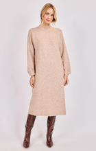 Load image into Gallery viewer, Woman wearing a beige knit turtleneck midi dress with long sleeves and brown knee-high boots.