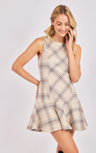 Load image into Gallery viewer, Woman wearing a beige plaid sleeveless drop waist mini dress with flared hem.