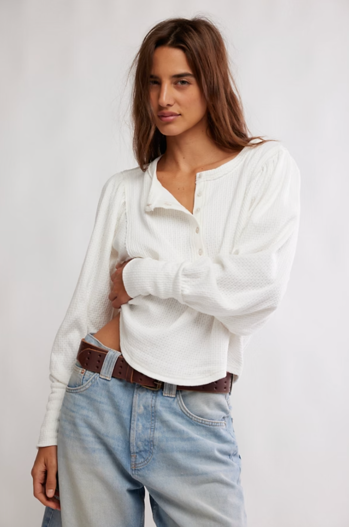 Woman wearing ivory Quinn Knit Top with balloon sleeves and henley neckline