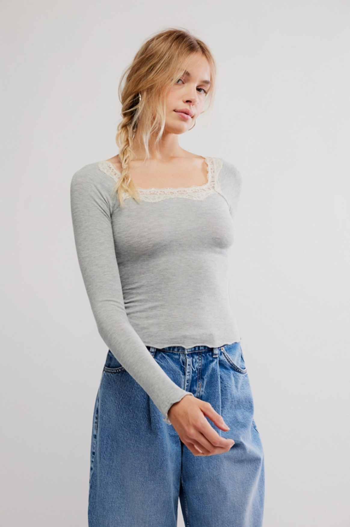 Woman wearing gray lace trim long sleeve micro rib top with lettuce edge hem
