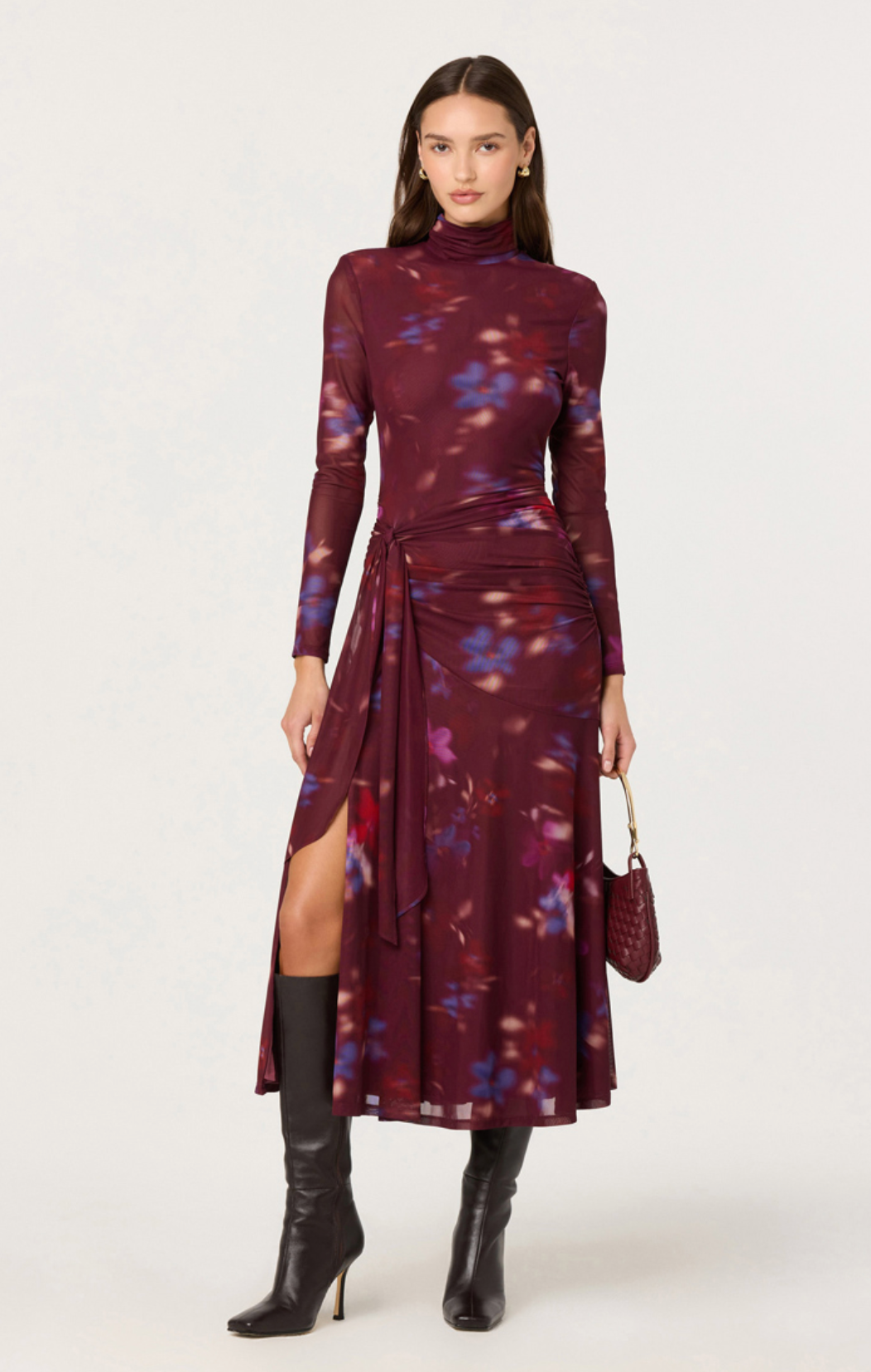 Model wearing the Aubriella burgundy floral mesh turtleneck midi dress with side tie detail and slit.