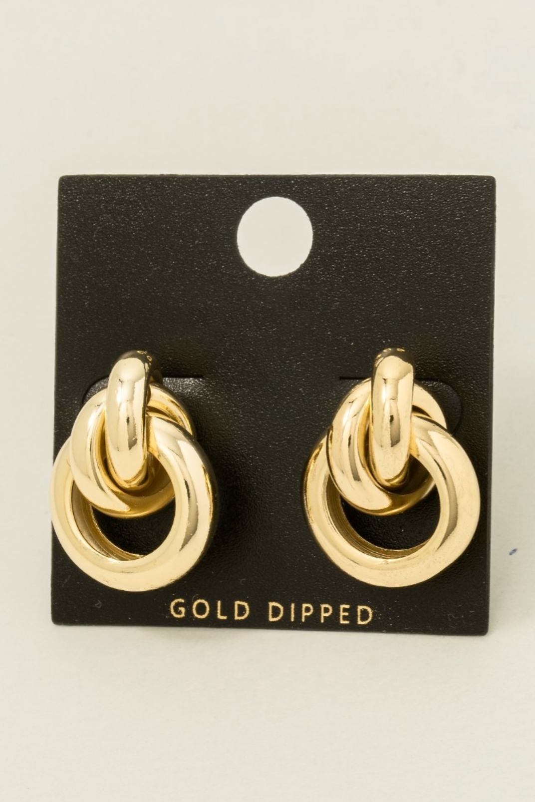 Gold-dipped thick layered door knocker earrings with interlocking loops on black card