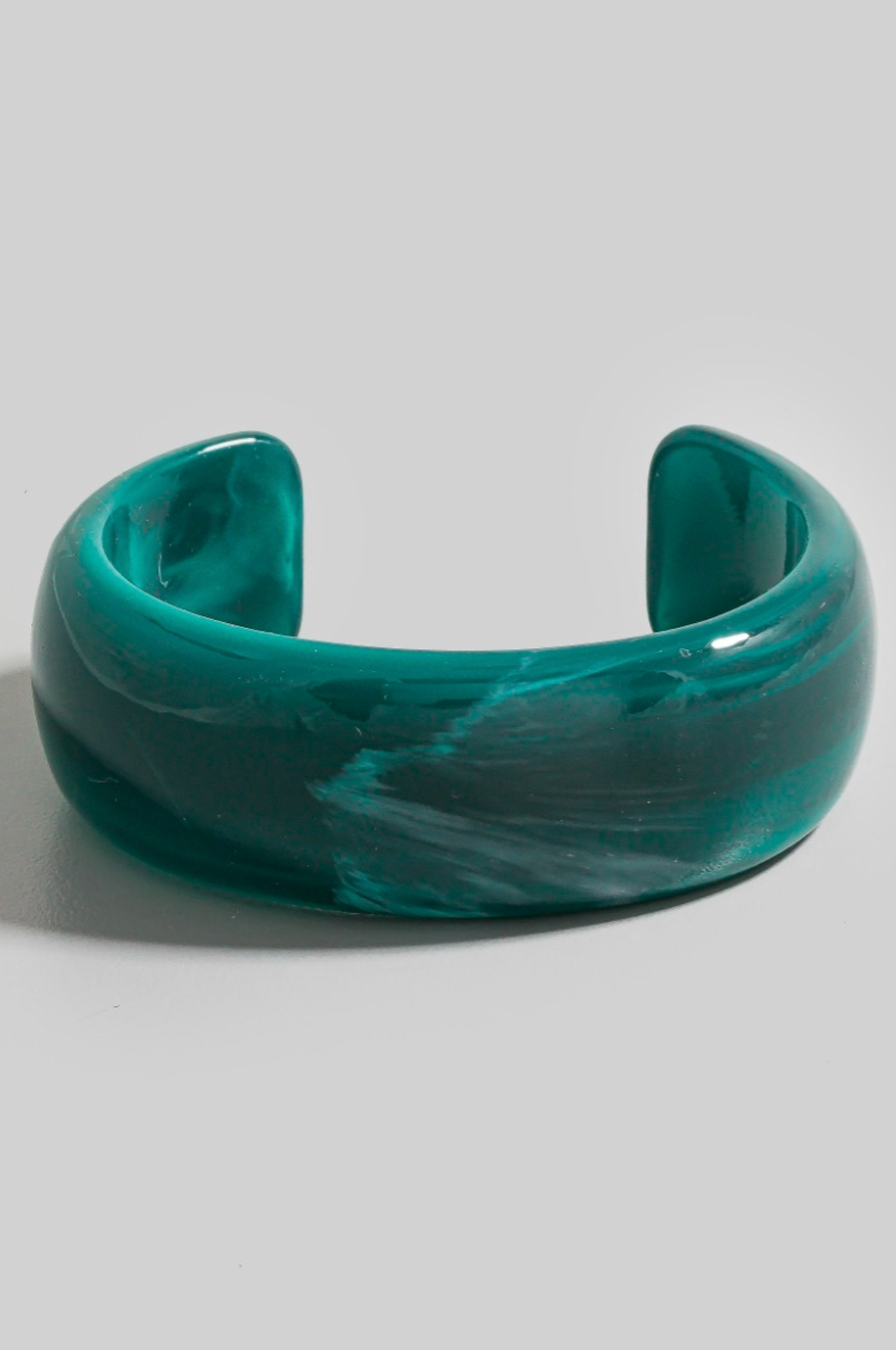 Wide marbled jade green resin cuff bracelet with curved sculptural design