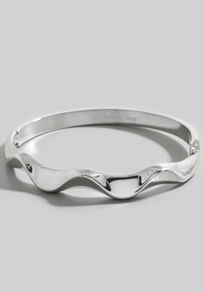 Silver bracelet on a light gray background