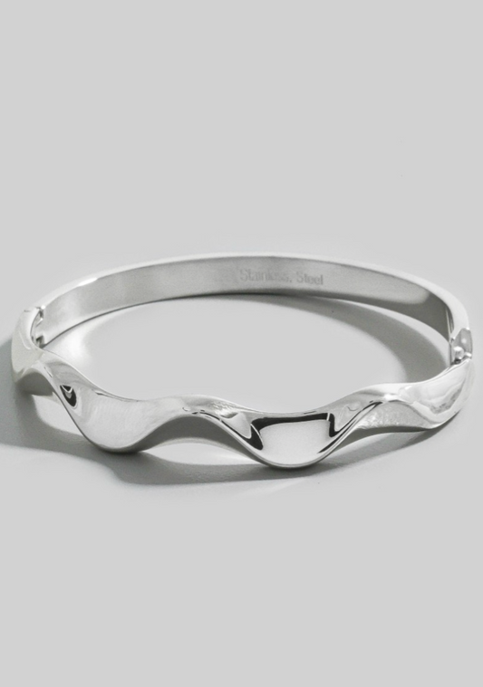 Silver bracelet on a light gray background