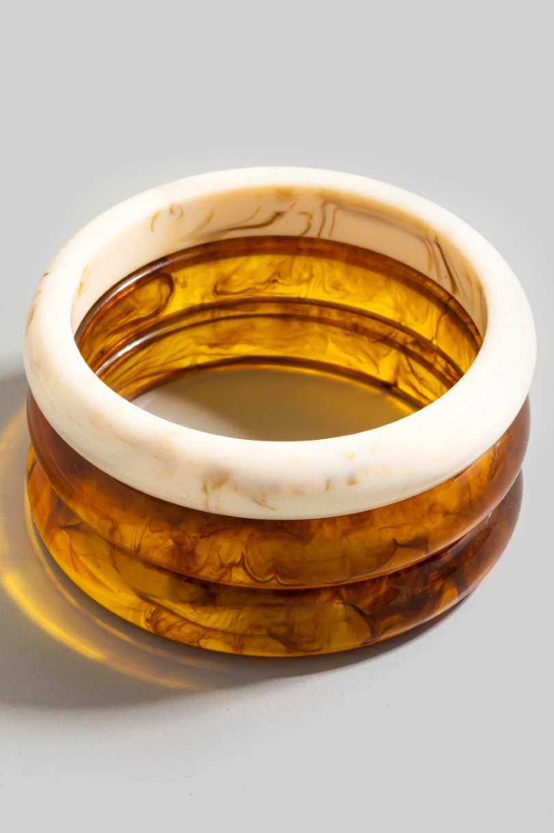 Three-piece marbled resin bangle bracelet set in amber and ivory tones