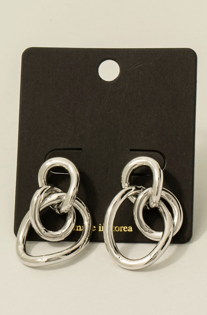 Silver sculpted loop statement earrings with linked abstract design