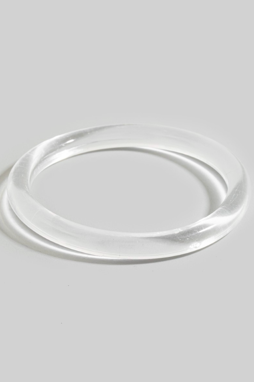 Rhea Resin Bangle Bracelet in clear resin with sleek tubular silhouette