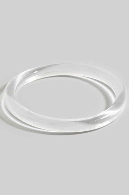 Rhea Resin Bangle Bracelet in clear resin with sleek tubular silhouette