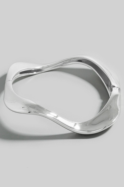 Mira Wave Metal Bangle in polished silver sculptural design