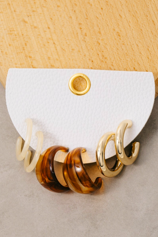 Metallic and marble resin hoop earrings set in gold, brown, and ivory tones