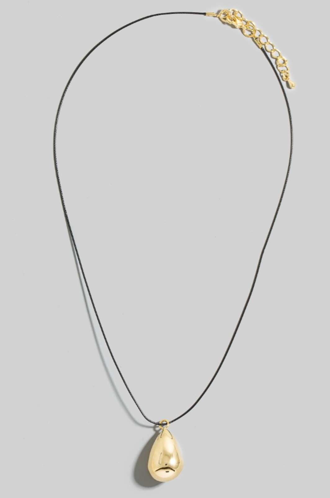 Gold teardrop pendant necklace on black cord