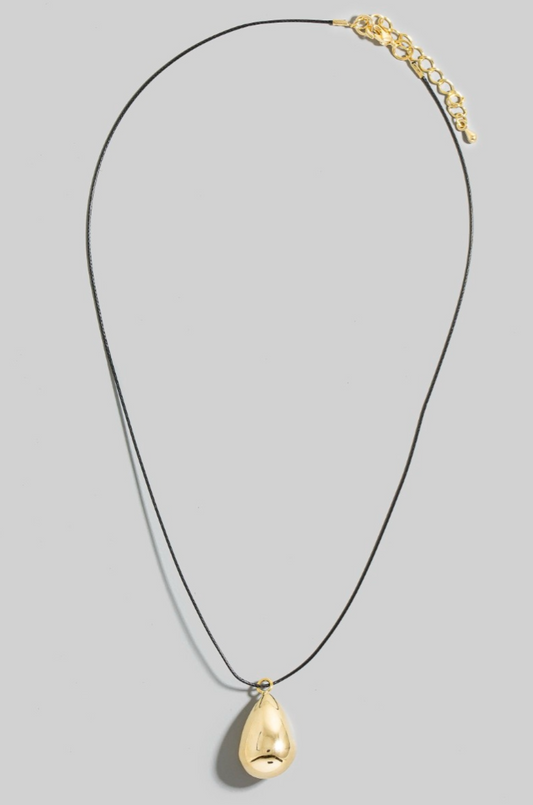 Gold teardrop pendant necklace on black cord