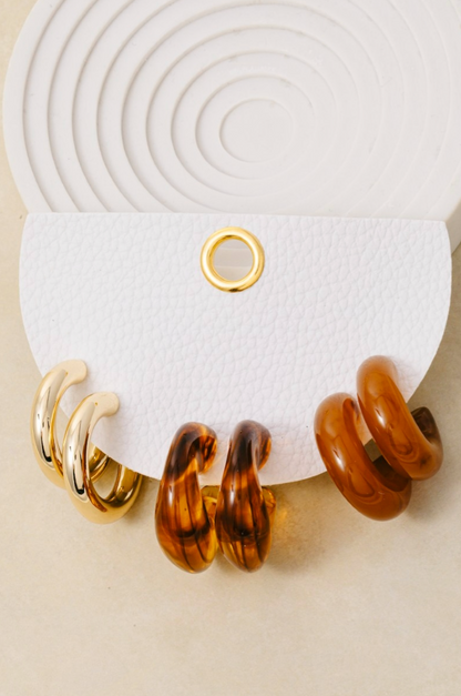 Metallic and marbled resin thick hoop earrings set in neutral tones