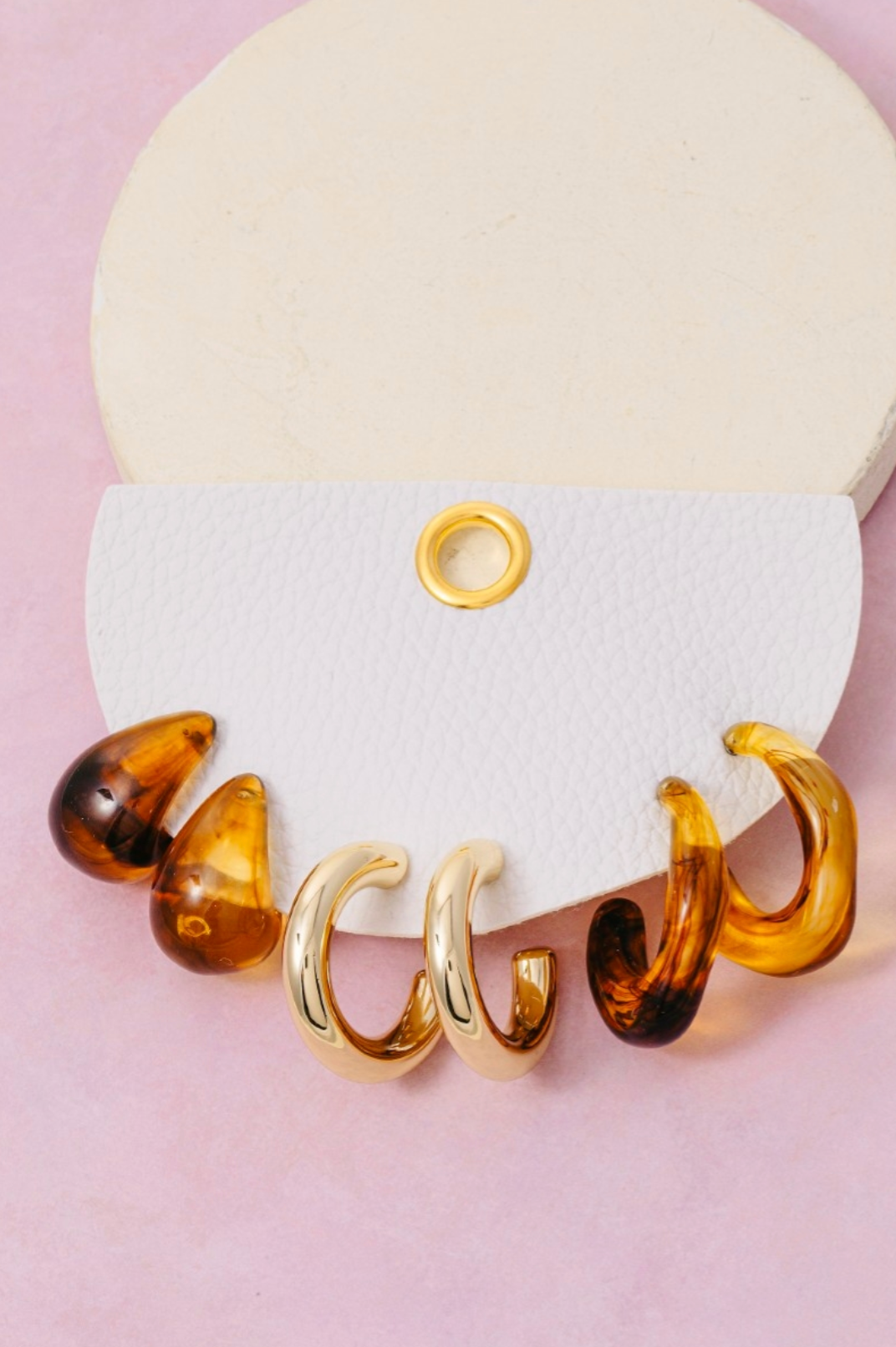 Metallic and marbled resin hoop earrings set in warm neutral tones
