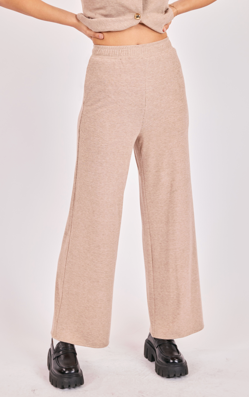 woman wearing beige knit wide-leg pull-on pants paired with matching sleeveless knit vest top