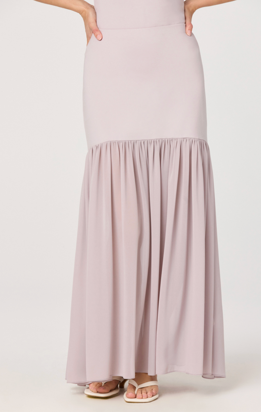 Light pink skirt worn by a person on a white background