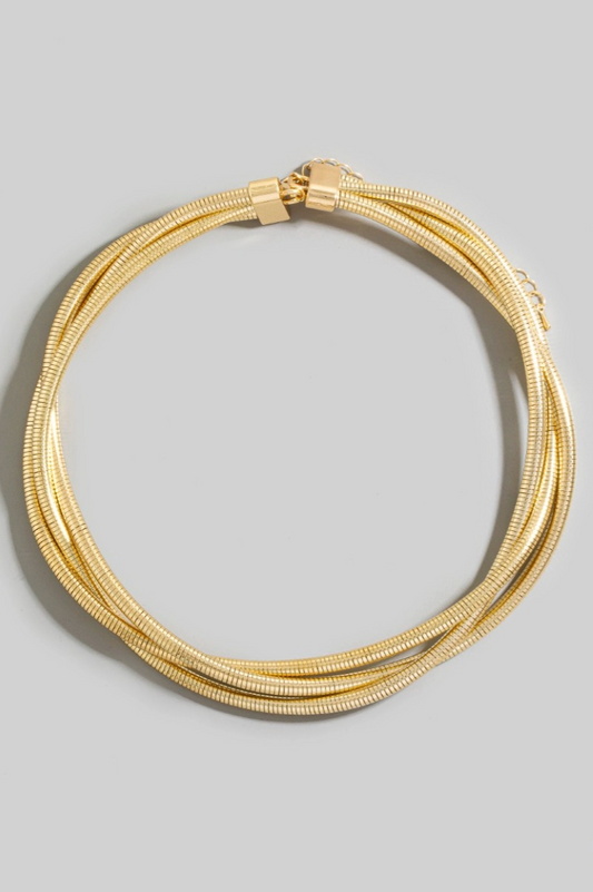 Gold bracelet on a gray background