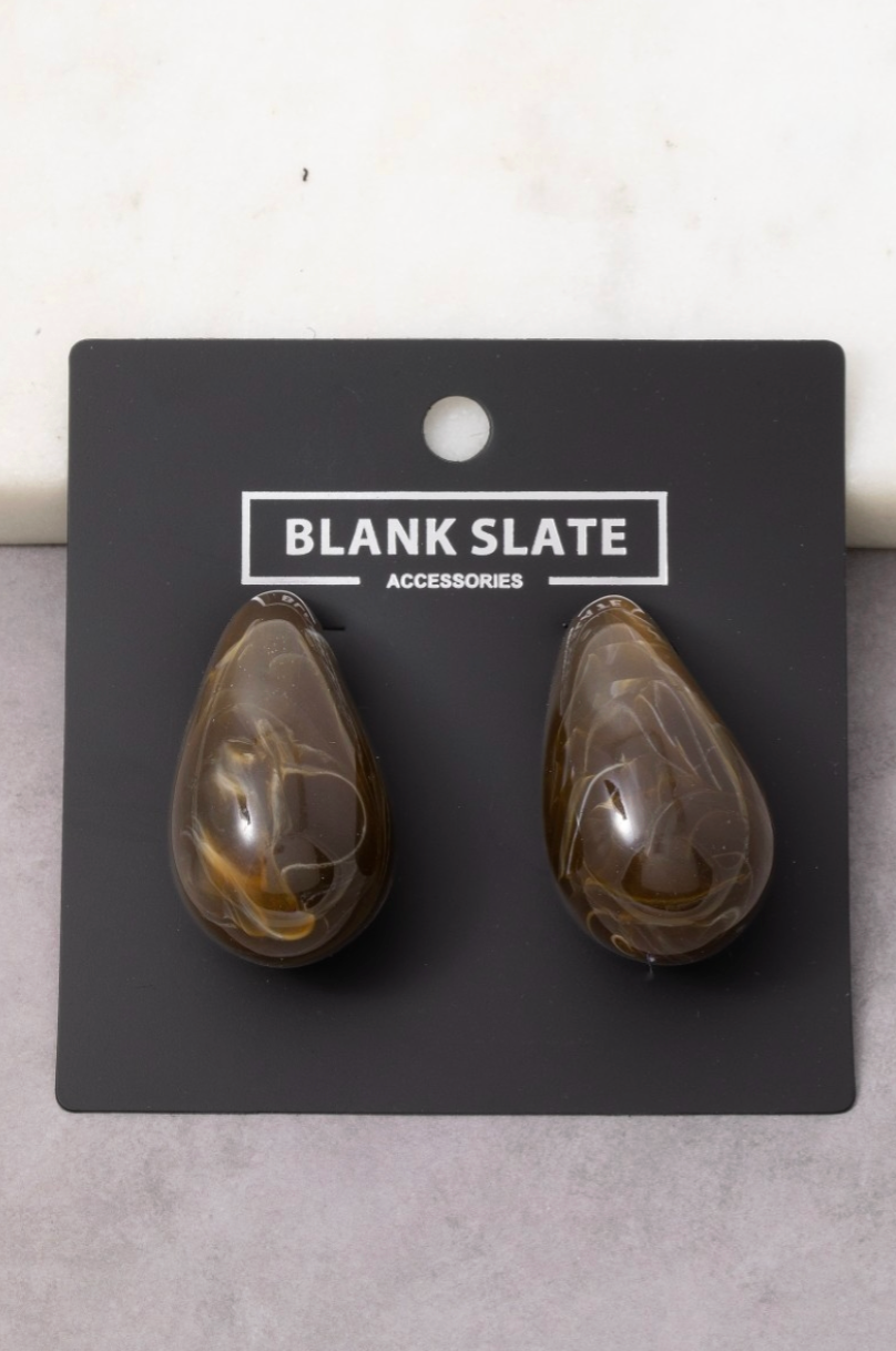 Teardrop-shaped earrings on a 'Blank Slate' branded card against a light gray background