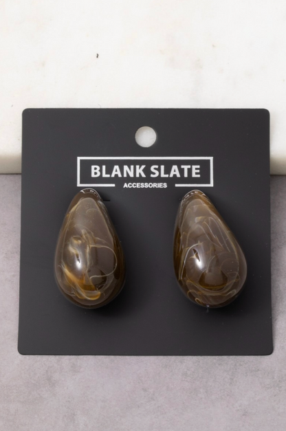Teardrop-shaped earrings on a 'Blank Slate' branded card against a light gray background