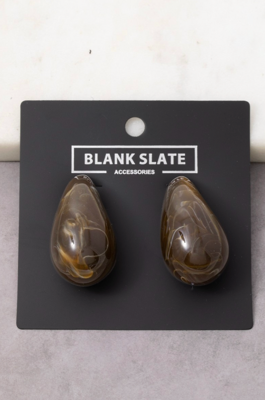 Teardrop-shaped earrings on a 'Blank Slate' branded card against a light gray background