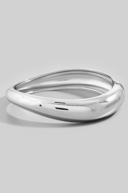 Silver bracelet on a light gray background