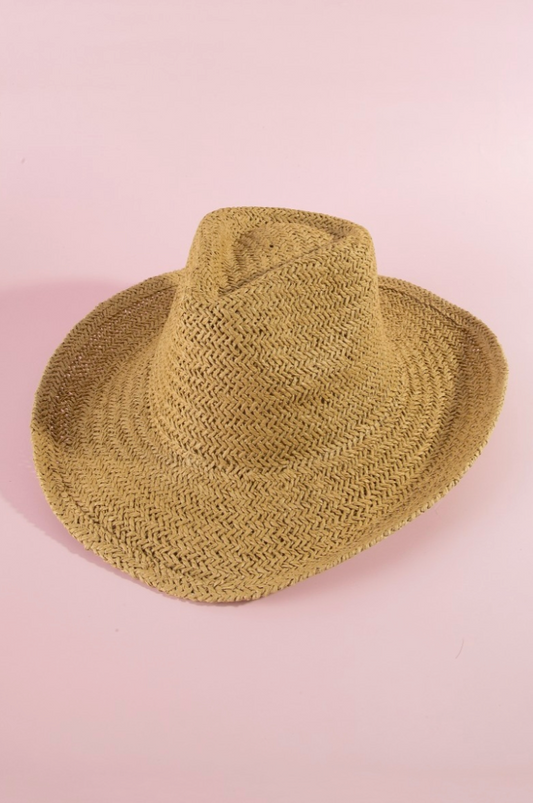 Green straw hat on a pink background