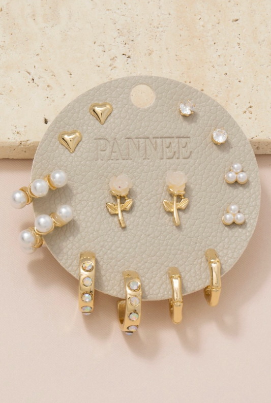 Set of gold and pearl earrings on a 'PANNEE' branded display card.