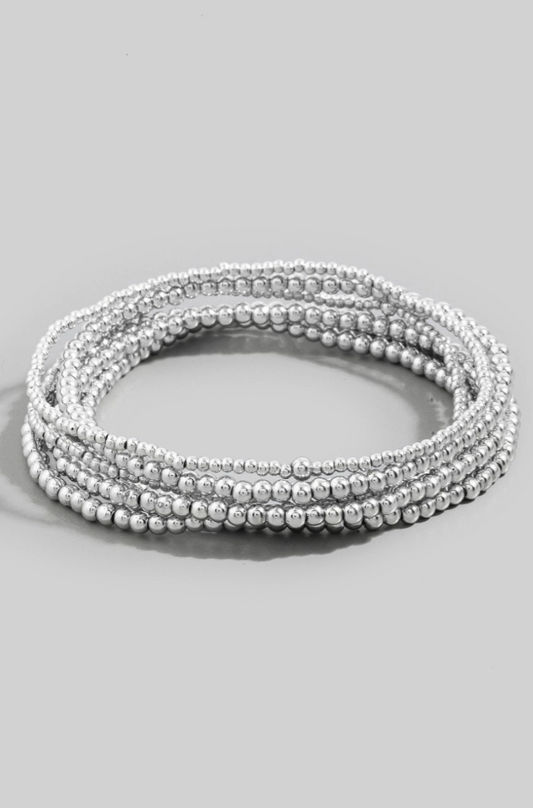 Silver beaded wrap bracelet on a light gray background