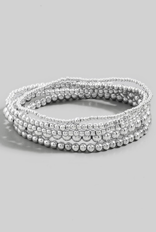 Silver beaded bracelet on a light gray background