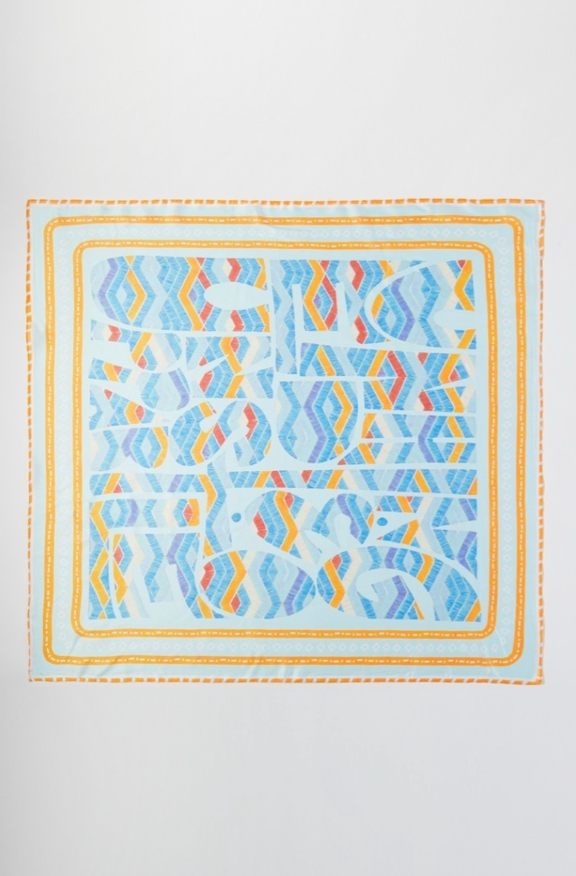 Colorful geometric patterned scarf on a white background