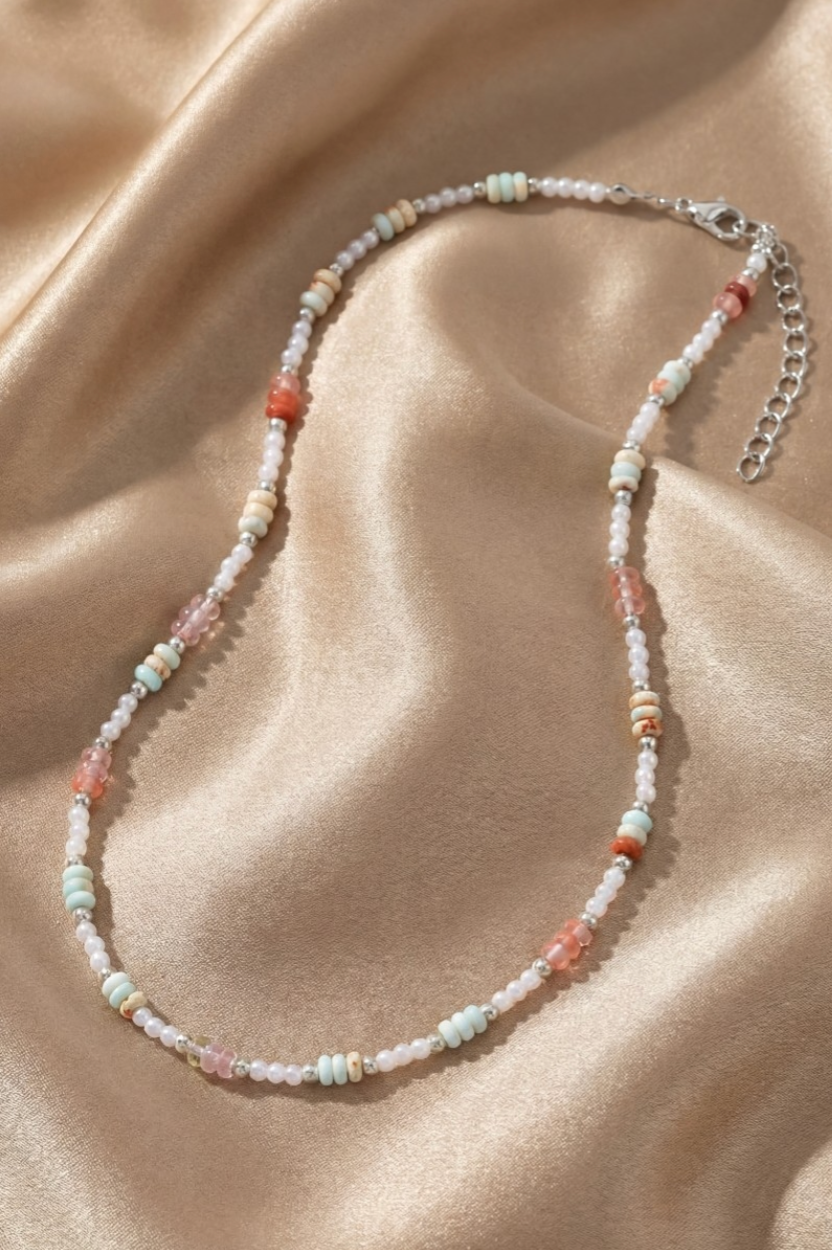 Beaded necklace on a beige fabric background