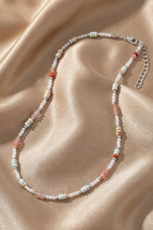 Beaded necklace on a beige fabric background