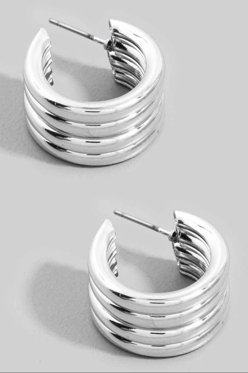 Silver ribbed chunky hoop earrings with a polished multi-ridge tubular design.