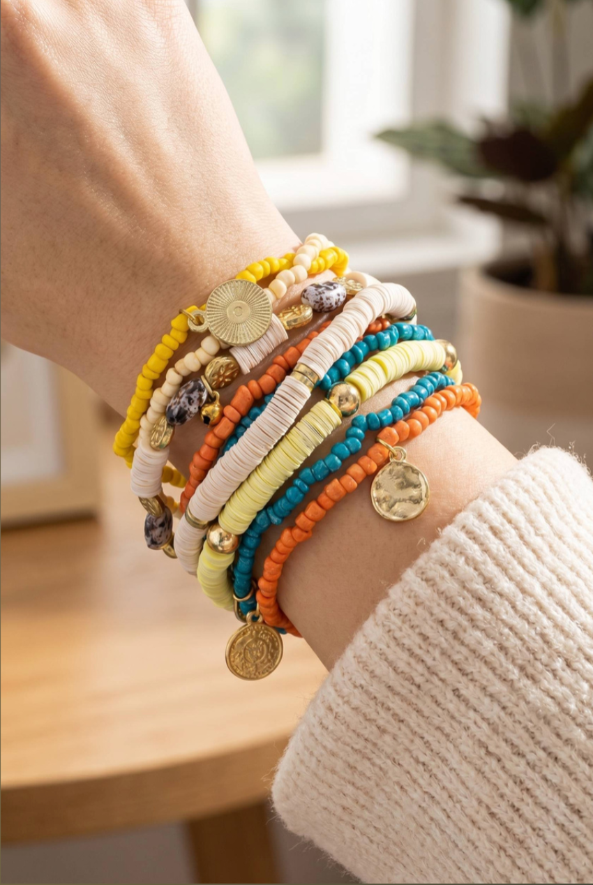 Multicolor stretch bracelet set with vinyl heishi beads, seed beads, spotted stone accents, and gold coin charms.