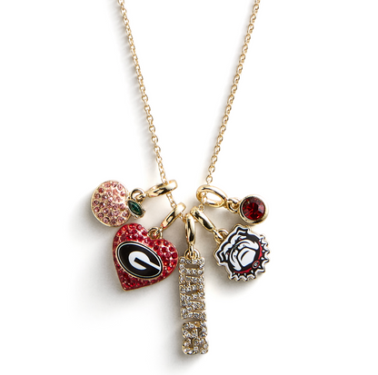 Gold University of Georgia charm necklace featuring the Georgia "G," Bulldog mascot, crystal "DAWGS" charm, peach charm, and red crystal accents.