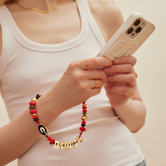 University of Georgia beaded phone charm featuring red, black, and gold beads with Georgia "G" logo and gold DAWGS lettering.