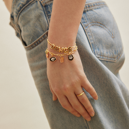 University of Georgia two-piece bracelet set featuring an adjustable DAWGS slider bracelet and gold charm bracelet with Georgia Bulldogs, G logo, peach, football, jersey, and mascot charms.