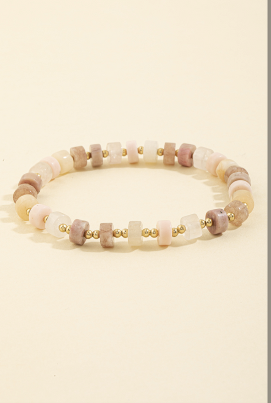 Stretch bracelet with pink, ivory, and taupe semi-precious stone beads accented by gold spacer beads.