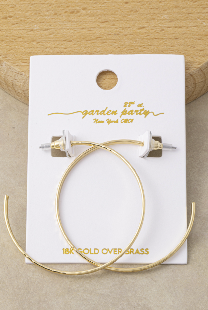 Extra-large thin gold hoop earrings with a hand-hammered 18K gold-dipped finish.