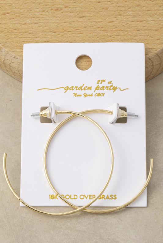 Extra-large thin gold hoop earrings with a hand-hammered 18K gold-dipped finish.
