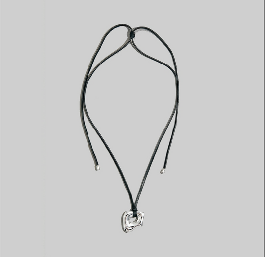 Black genuine leather adjustable cord necklace with a sculptural abstract silver pendant.