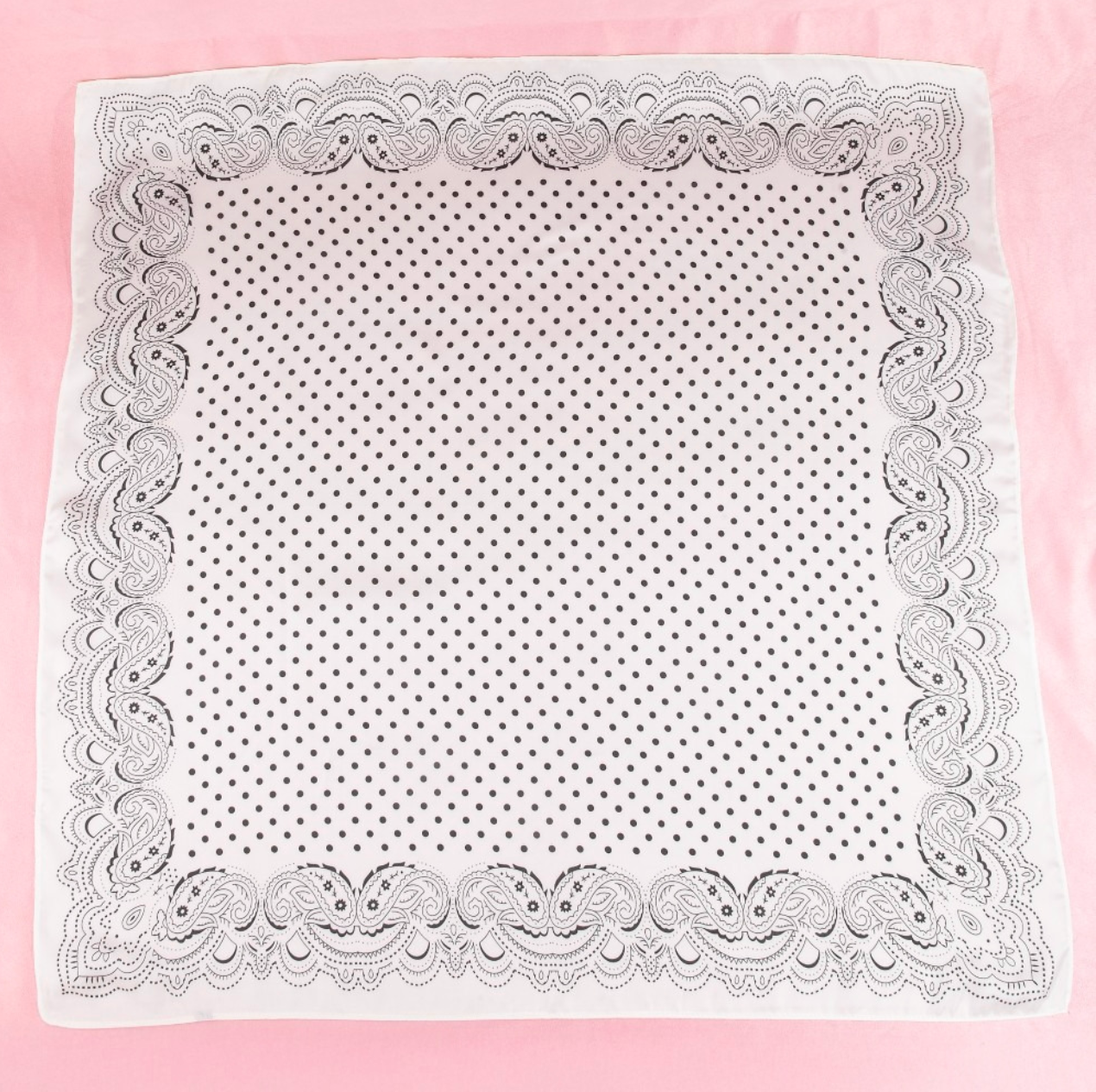 White satin square scarf with black paisley border and black polka dot print.