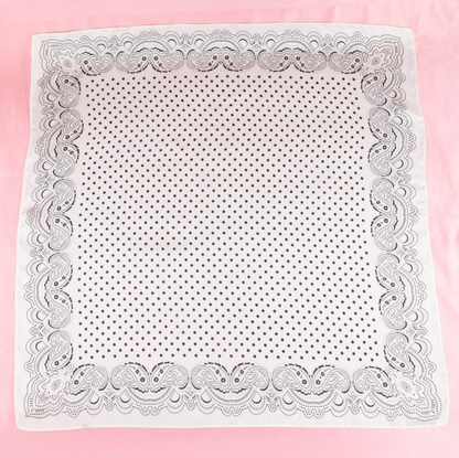White satin square scarf with black paisley border and black polka dot print.