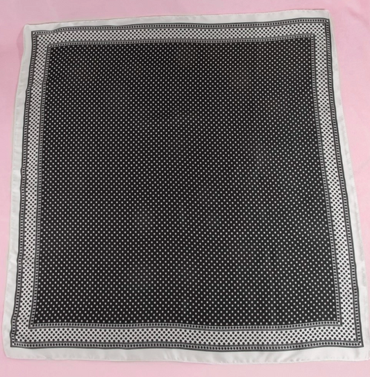 Black square scarf with a classic white polka dot pattern and coordinating white border.